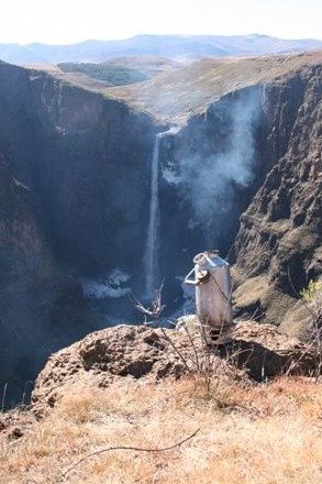 A STORM Kettle on the edge of a cliff with a waterfall in the distance